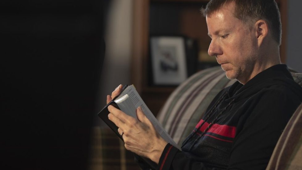 A relaxed Bible study group with open Bibles, focused on learning together.