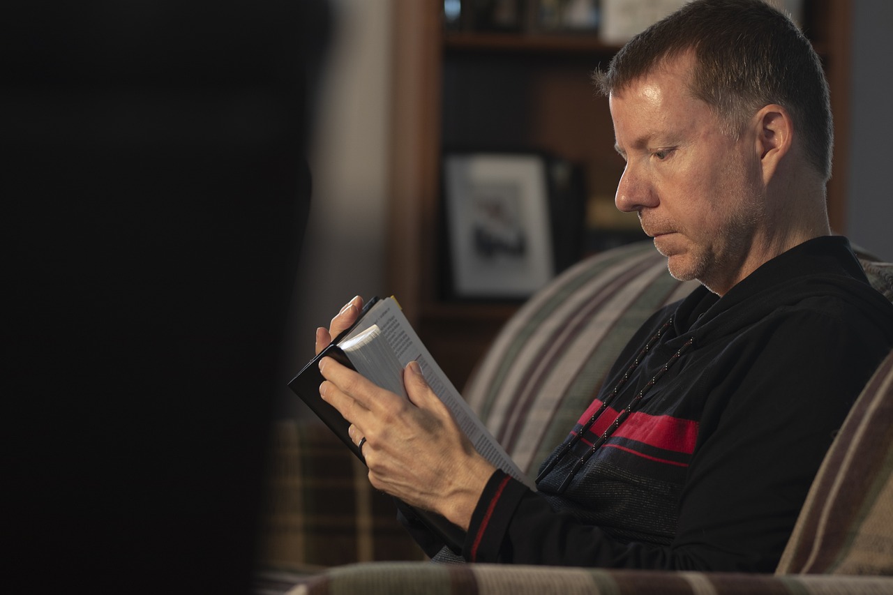 A relaxed Bible study group with open Bibles, focused on learning together.